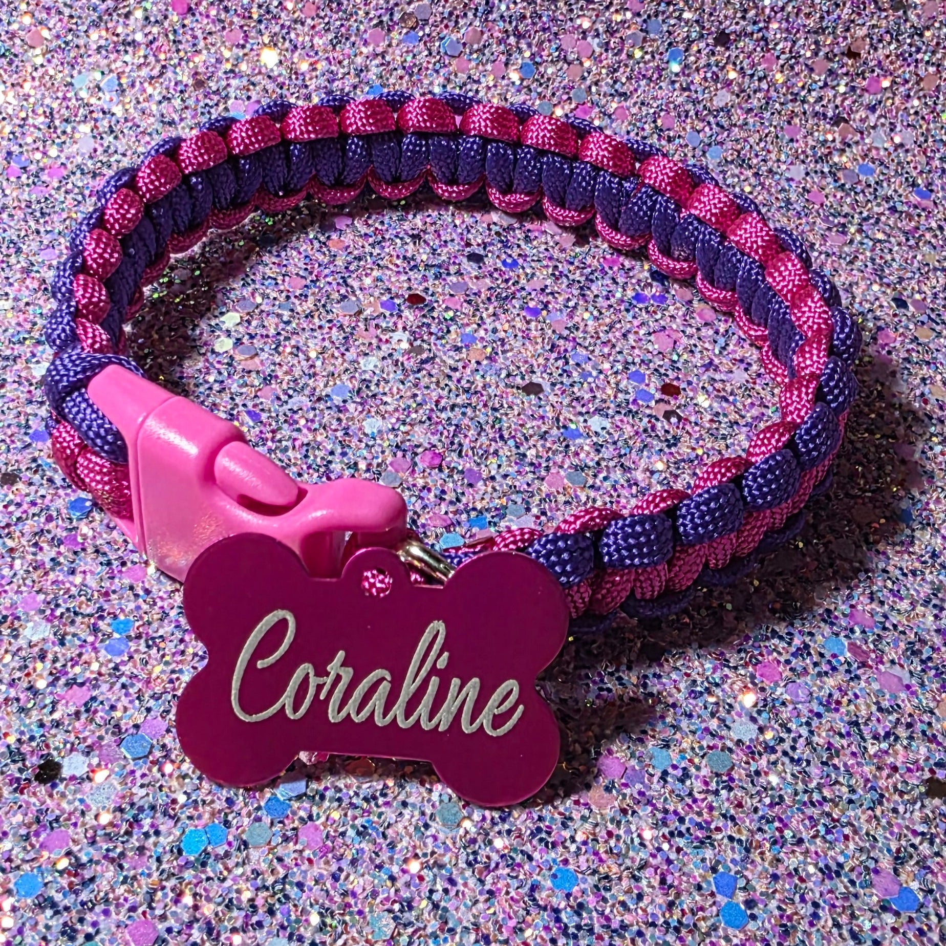 Pink and purple dog collar with a name tag on a glittery background