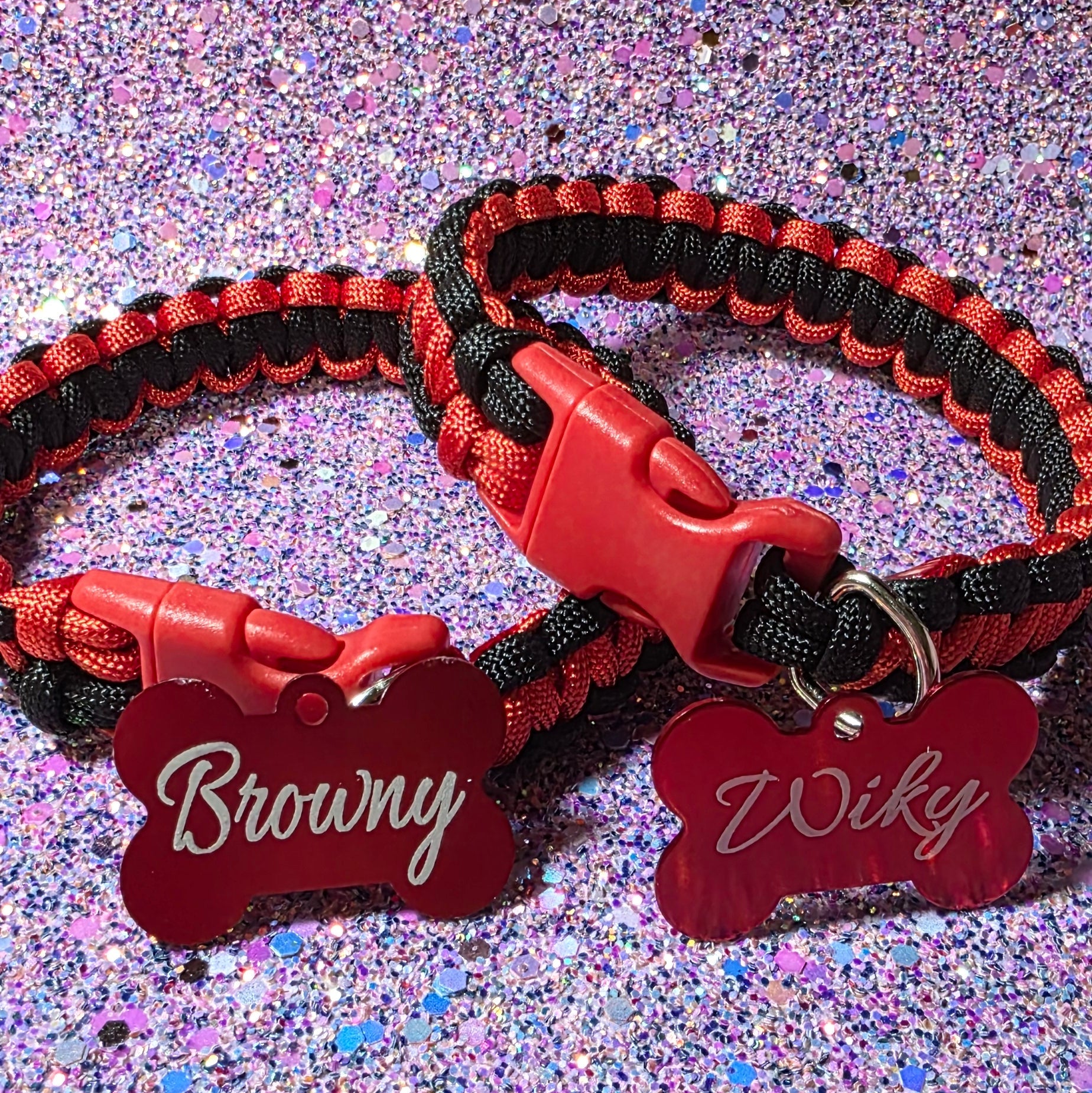 Red and black dog leash with a branded tag on a glittery purple background